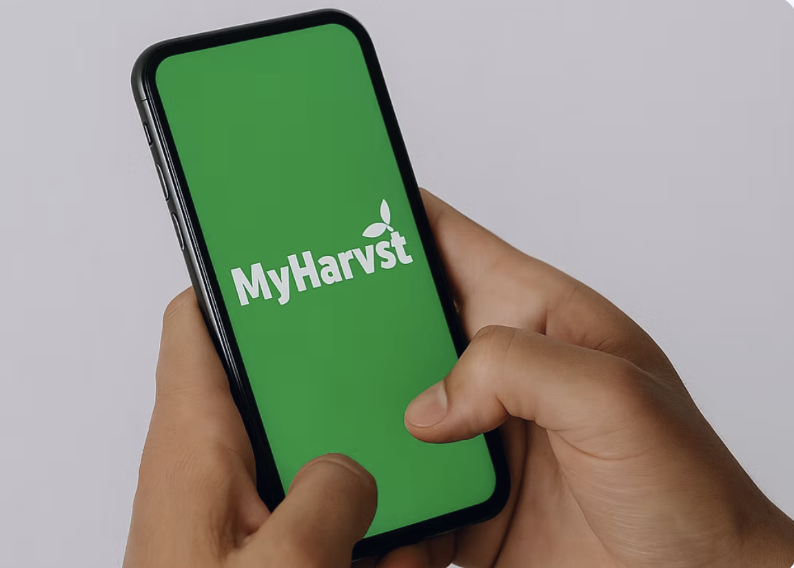 Hand holding MyHarvst app